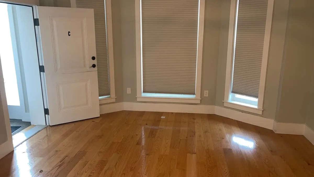The same living room cleared down to bare floor