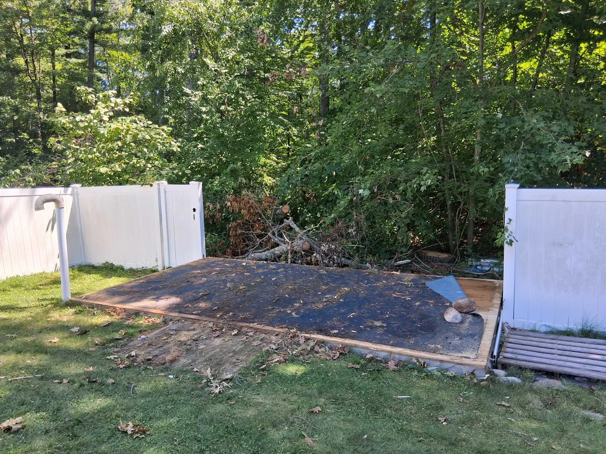 The bare platform left behind after a Trash Can Willy's crew took a backyard shed down and hauled it away