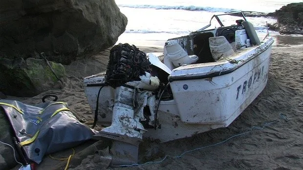 A junk runabout with a dead outboard hanging off the transom, the kind of boat we haul away