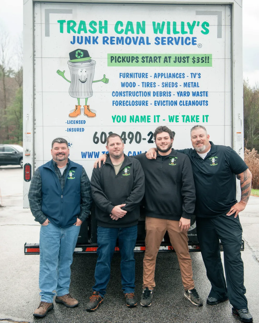 The Trash Can Willy's crew in branded polos in front of one of their junk removal box trucks